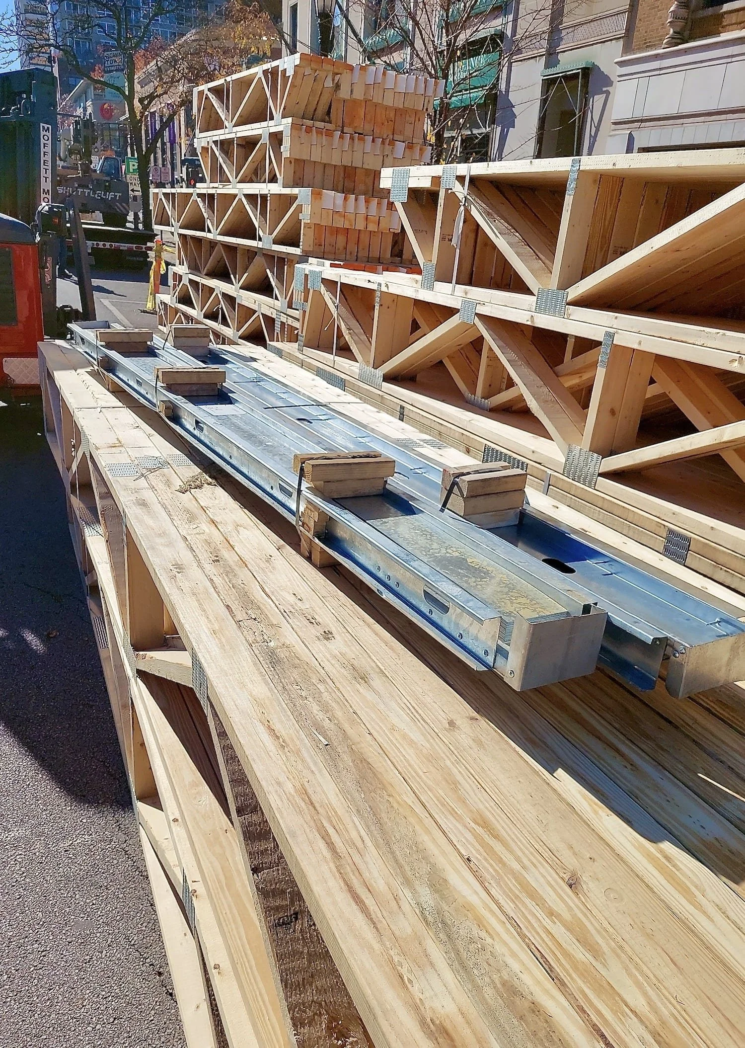 Pre-built framing assemblies and trusses staged on the street in Evanston — ready for installation